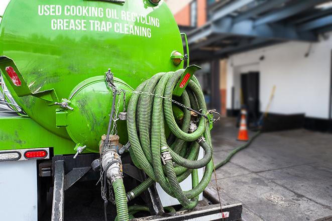 a service truck pumping grease from a restaurant's grease trap in Chestnut Hill